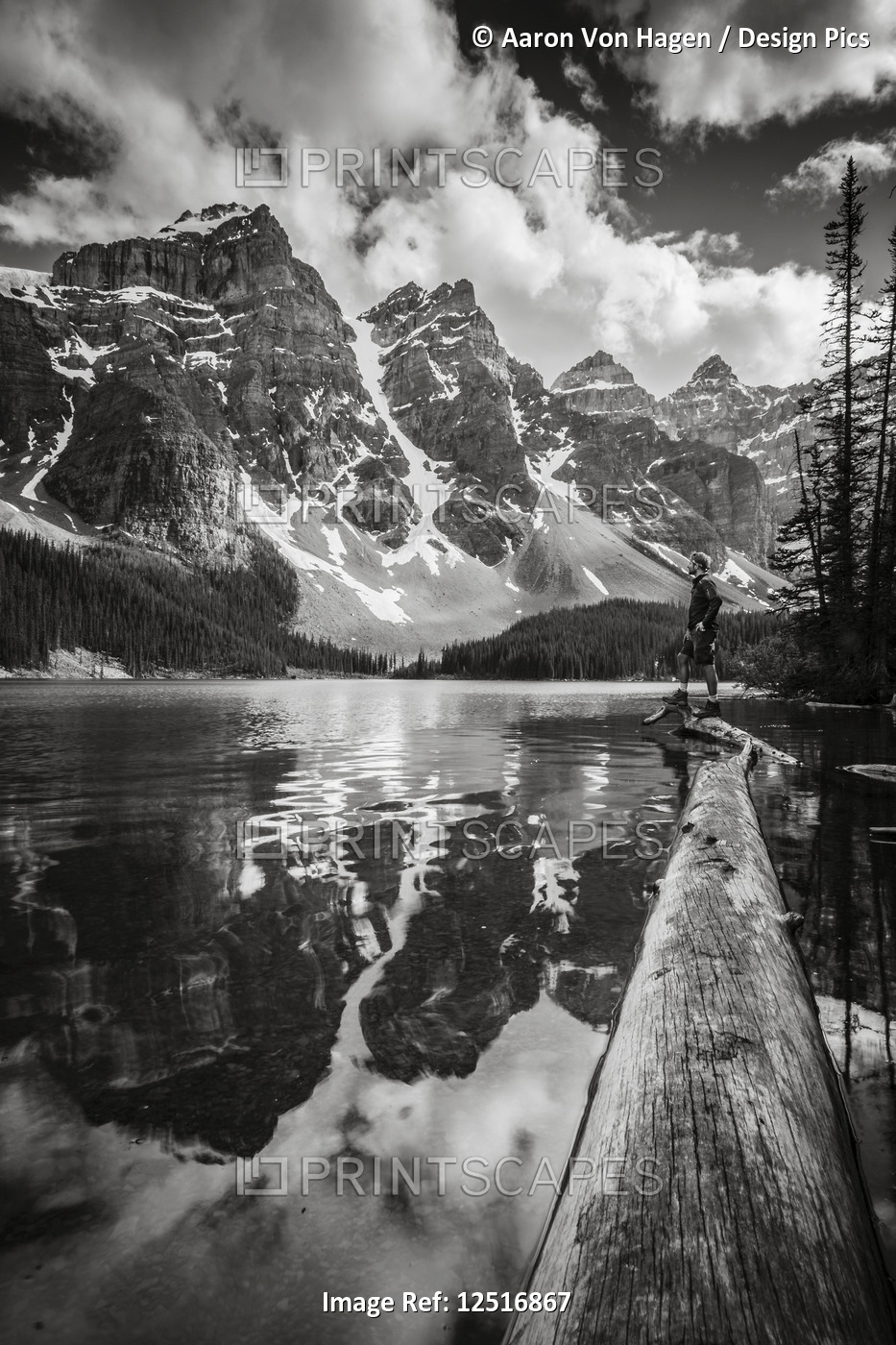 Rugged peaks of the Rocky Mountains reflected in a lake in Banff National Park; ...