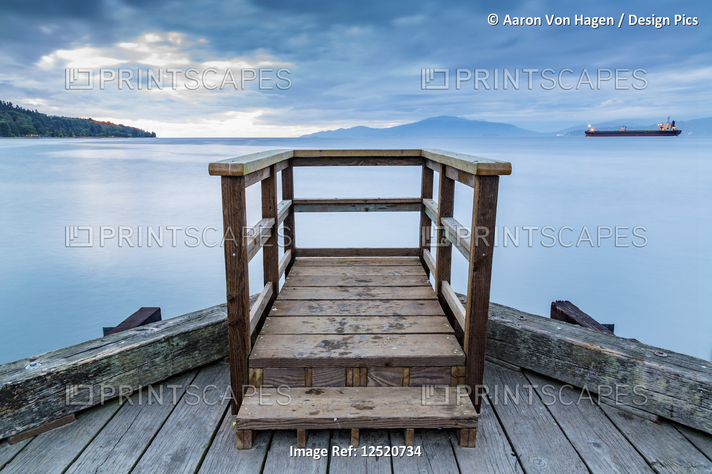 A wooden viewing platform at the end of a dock looks out to a ship on the ...